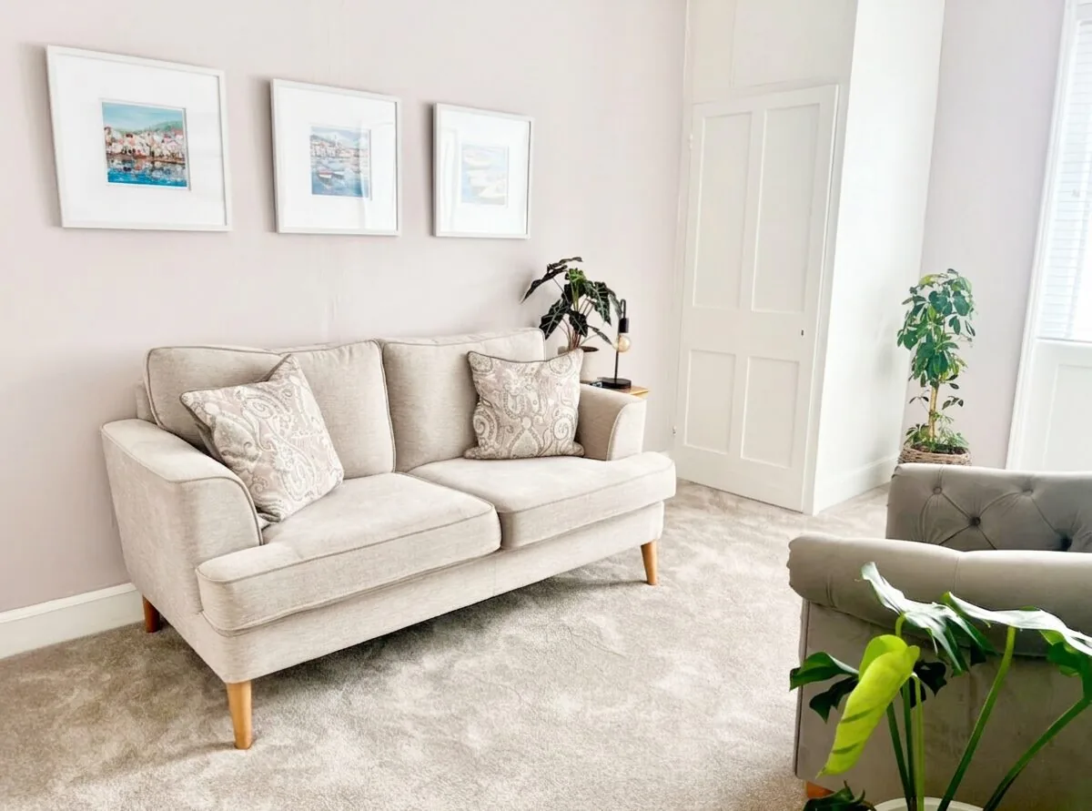 Welcoming therapy space in Hereford with comfortable seating, coastal artwork and indoor plants